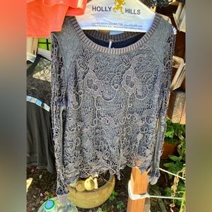 Free People sweater with pattern cutout sleeves.